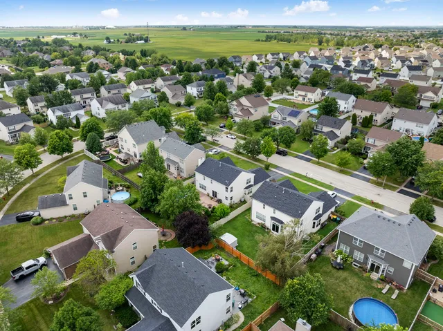 an aerial view of residential houses with outdoor space