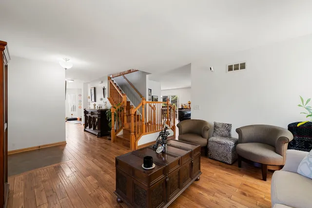 a living room with furniture and stairs