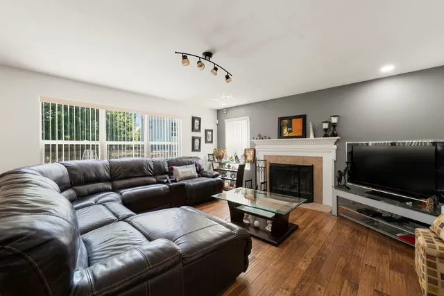 a living room with furniture a flat screen tv and a fireplace