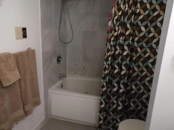a bathroom with a bathtub and a shower