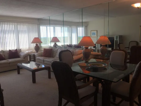 a dining room with furniture and a chandelier