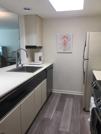 a kitchen with a sink and a refrigerator