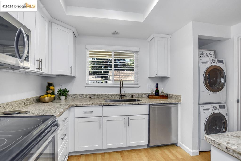 2587 Oak Road, Unit A Walnut Creek, CA 94597 - Photo 1 of 1 a kitchen with granite countertop a sink a stove and cabinets