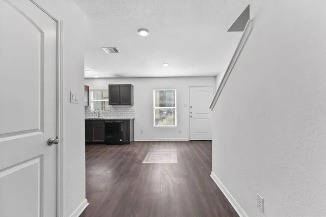 a view of a kitchen with a sink cabinet and a window