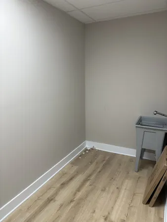 a view of a room with wooden floor and a window