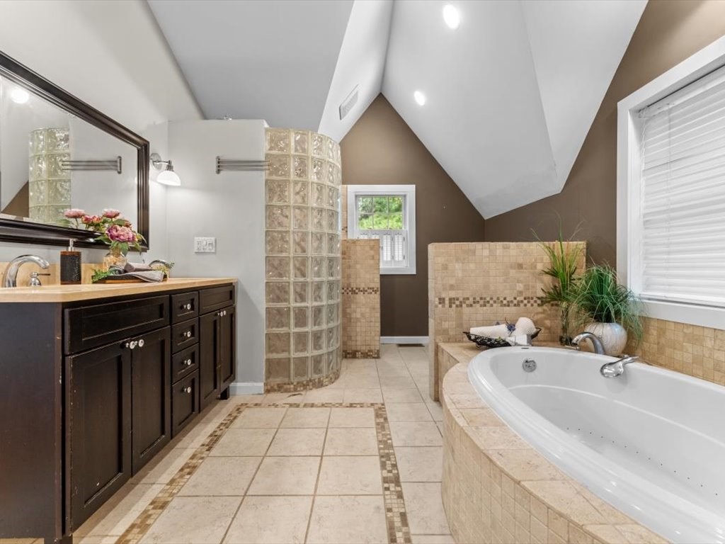 39 Evergreen Road Natick, MA 01760 - Photo 21 of 36 a spacious bathroom with a double vanity sink a mirror and a bathtub