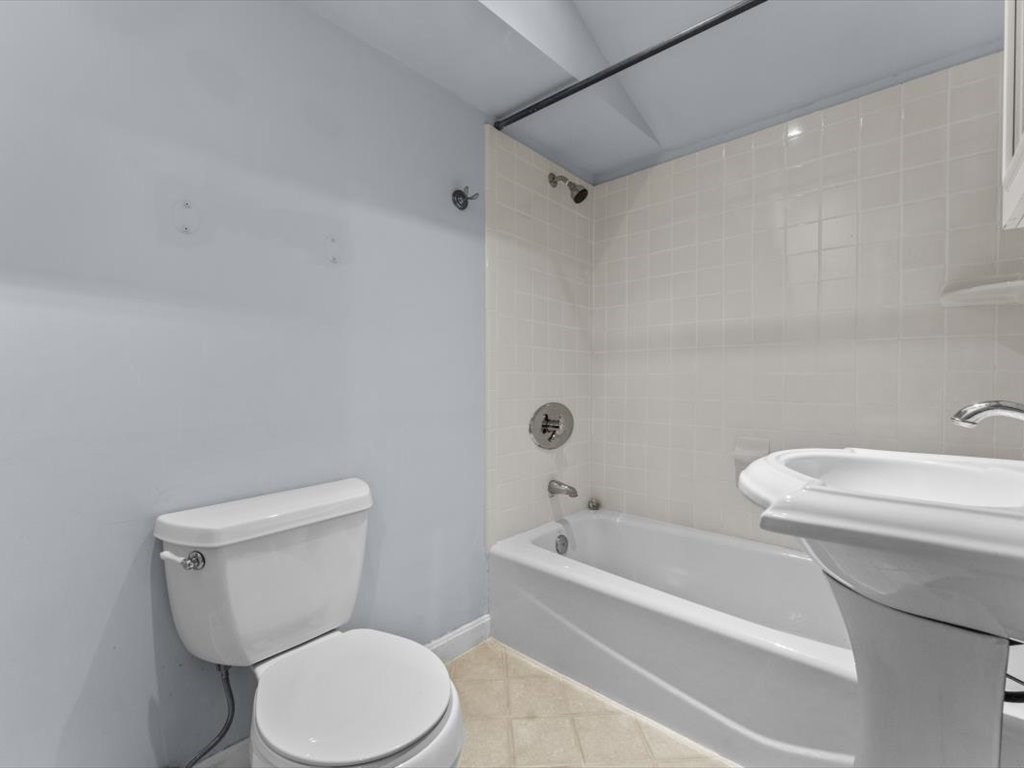 39 Evergreen Road Natick, MA 01760 - Photo 27 of 36 a white toilet and a shower curtain