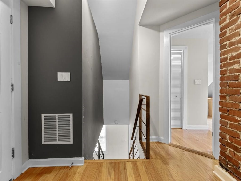 39 Evergreen Road Natick, MA 01760 - Photo 29 of 36 a view of a bedroom with a bed and wooden floor
