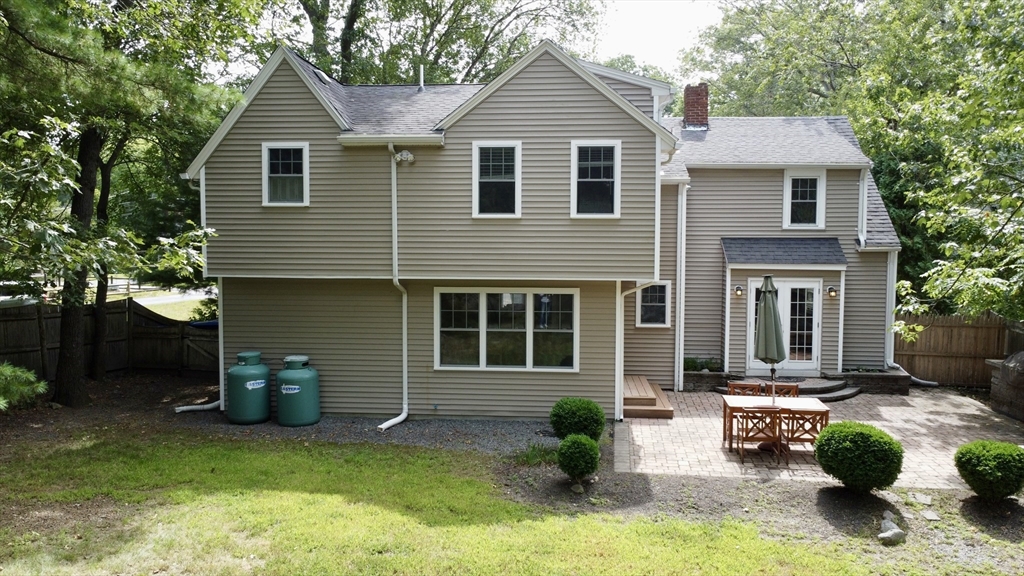39 Evergreen Road Natick, MA 01760 - Photo 34 of 36 a front view of a house with a yard and potted plants