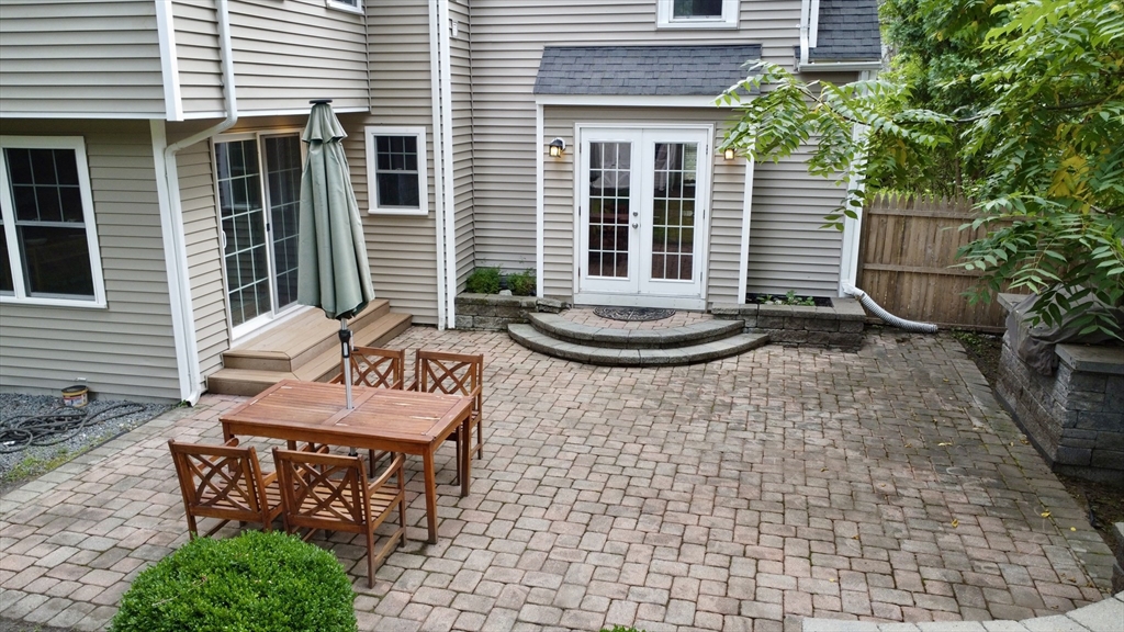 39 Evergreen Road Natick, MA 01760 - Photo 35 of 36 a view of a patio with table and chairs and potted plants