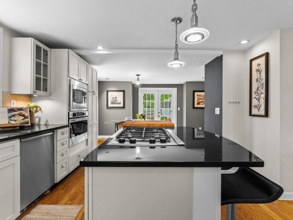39 Evergreen Road Natick, MA 01760 - Photo 8 of 36 a kitchen with stainless steel appliances granite countertop a sink stove and refrigerator