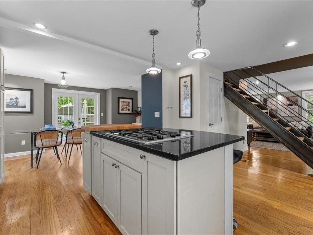 39 Evergreen Road Natick, MA 01760 - Photo 9 of 36 a kitchen with stainless steel appliances granite countertop a stove oven a dining table and chairs with wooden floor