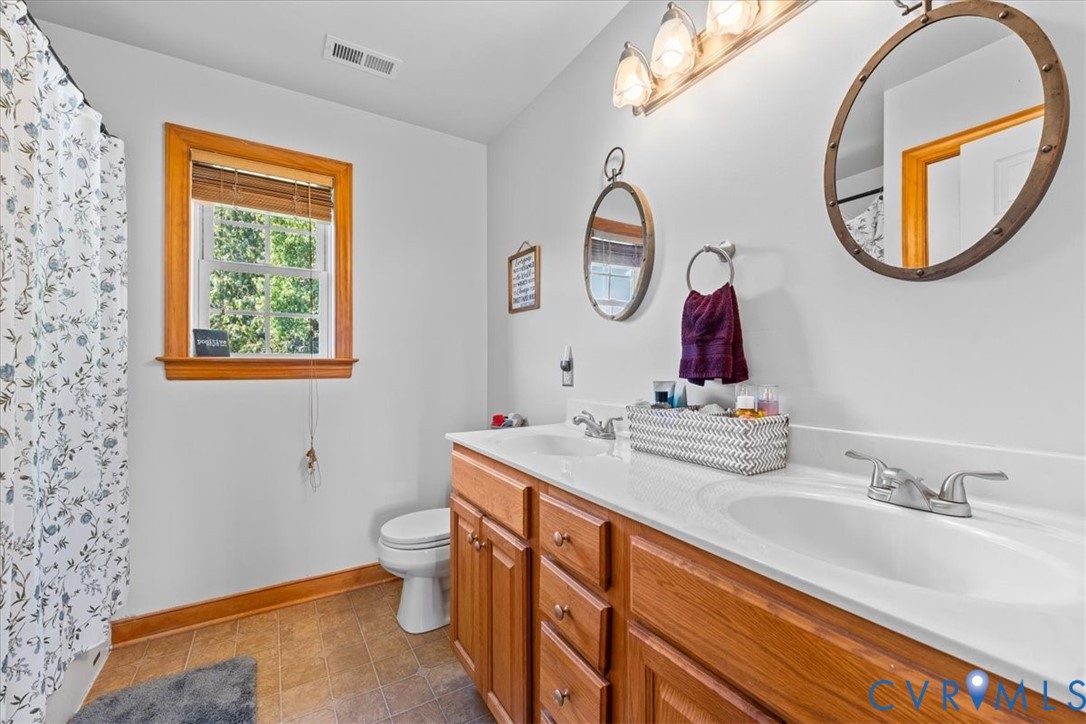 3137 Trenholm Road Powhatan, VA 23139 - Photo 33 of 72 a bathroom with a sink and a mirror