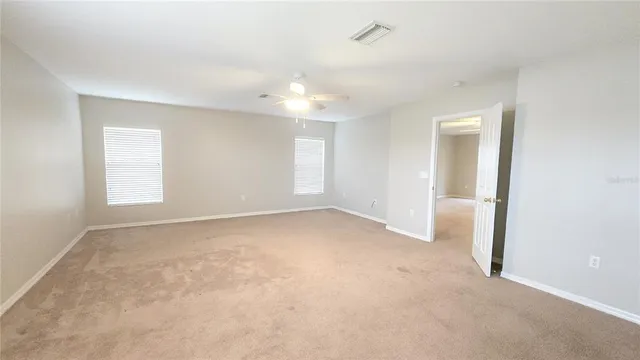 an empty room with windows and closet