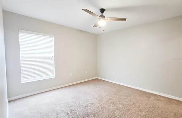 an empty room with a empty space and a ceiling fan