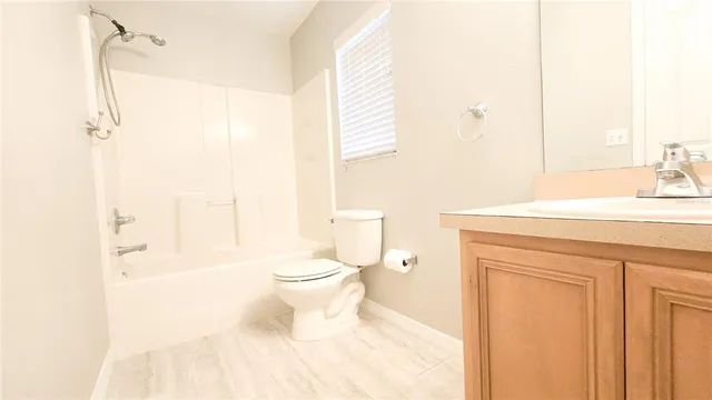 a view of an empty room with a chandelier fan