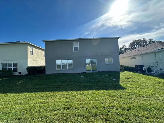 a view of a storage & utility room with refrigerator and windows