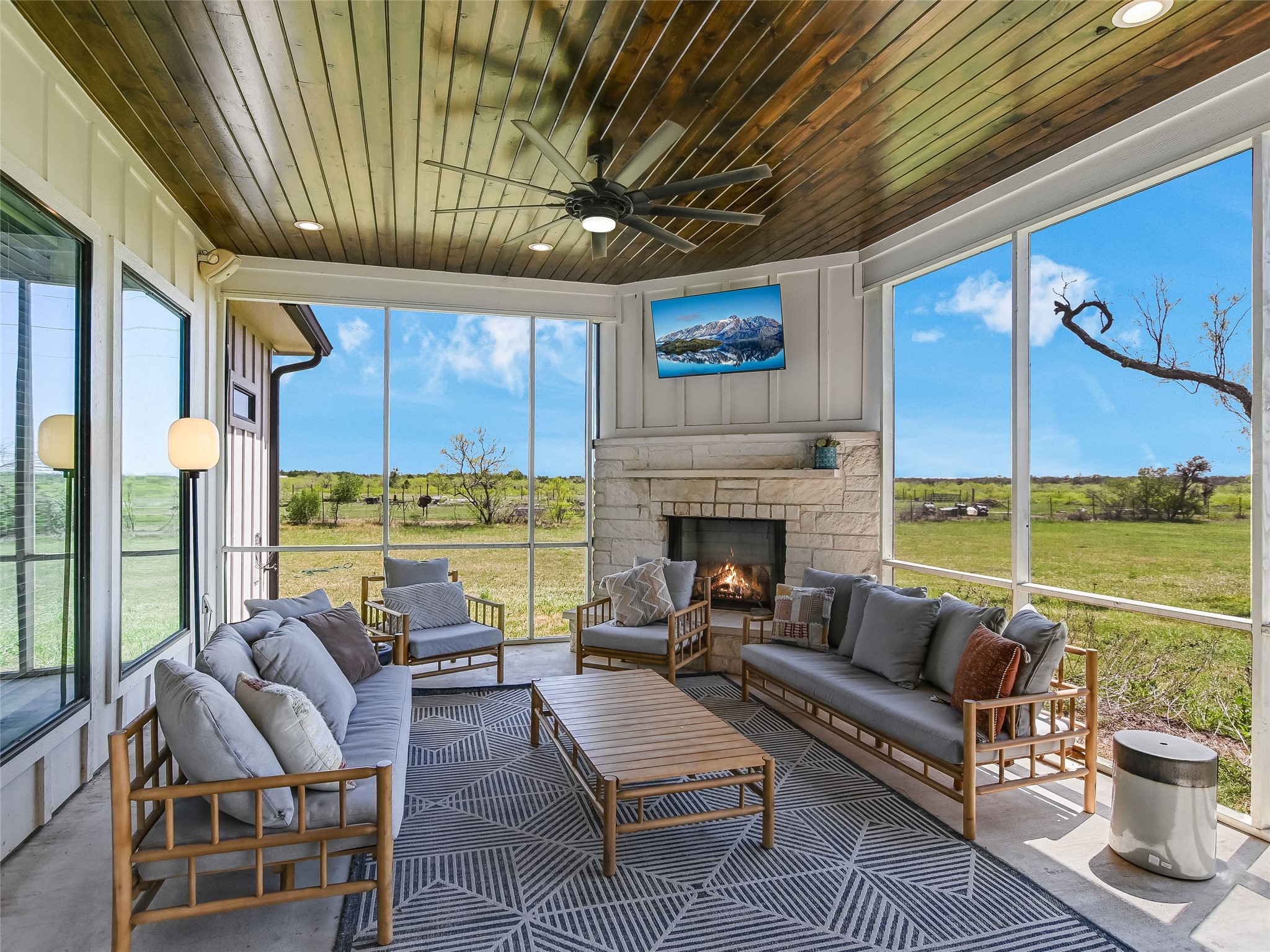 19819 Lockwood Road Manor, TX 78653 - Photo 22 of 29 Framed by scenic countryside and protected from the elements, this screened outdoor lounge with a stone fireplace becomes your go-to spot for morning coffee or stargazing