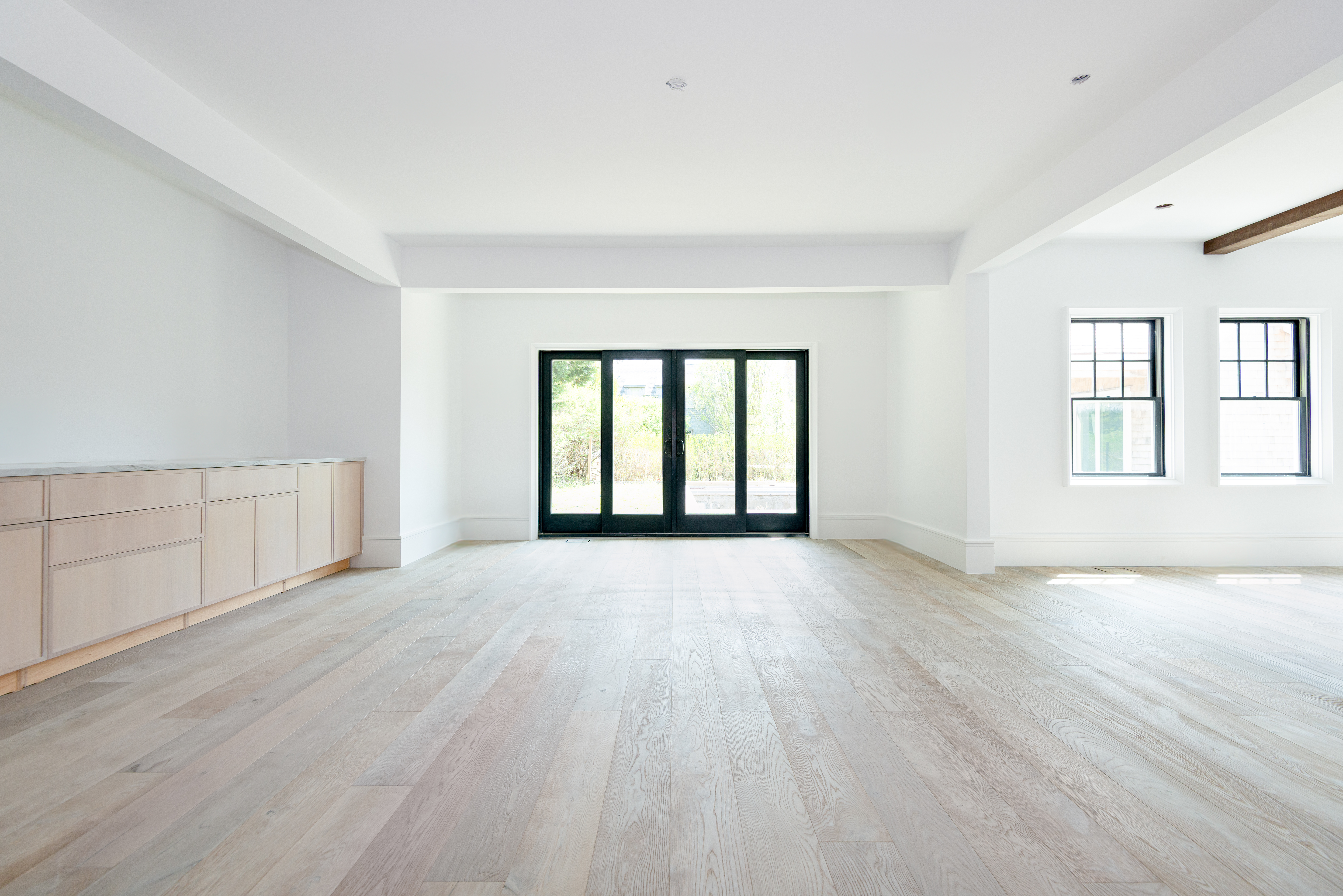 84 Cliff Road Nantucket, MA 02554 - Photo 7 of 12 an empty room with wooden floor and windows