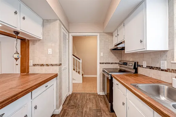 a kitchen with a sink stove and refrigerator