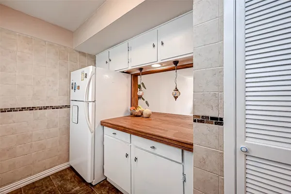 a kitchen with a refrigerator and countertop