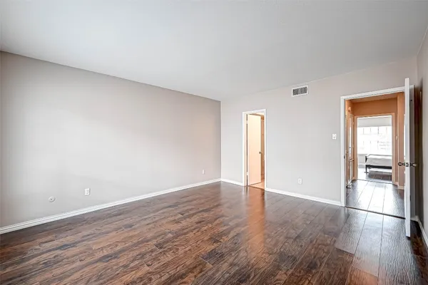 a view of wooden floor and windows in a room