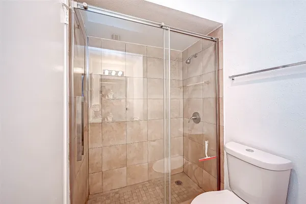 a bathroom with a shower and toilet