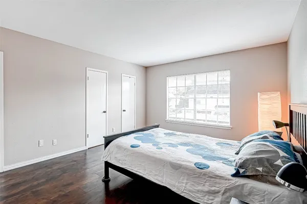 a bedroom with a bed and a window