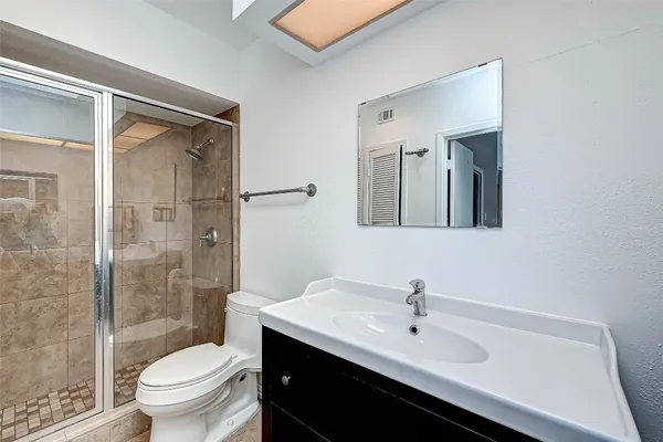 a bathroom with a sink toilet and shower