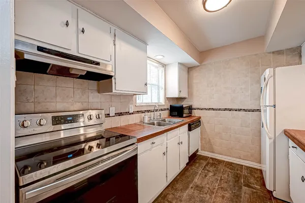 a kitchen with a sink stove and refrigerator