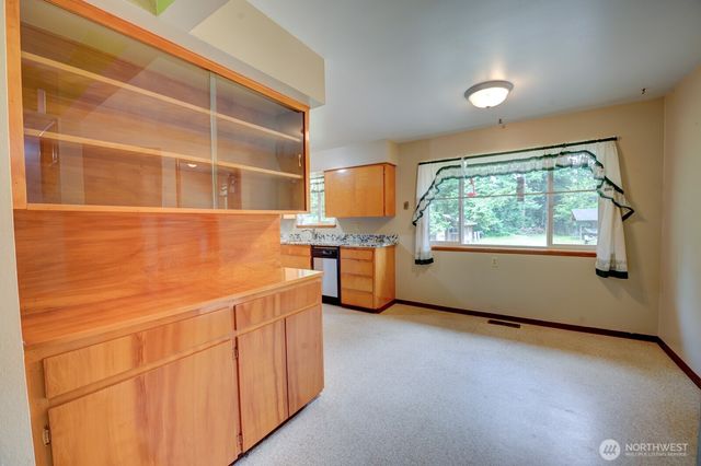 a bathroom with a granite countertop sink a vanity and mirror