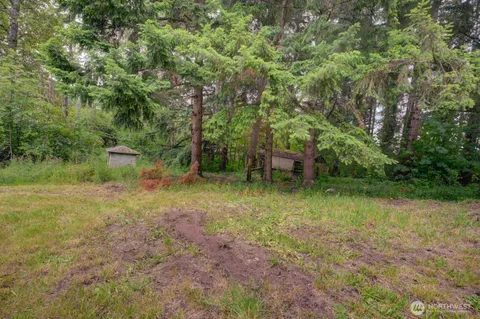 a yellow house with trees in front of it