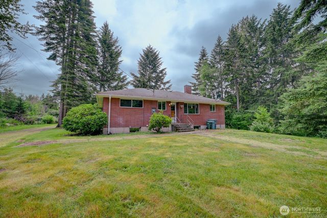 a view of a big yard with a house in the background