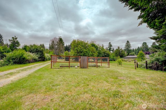 an aerial view of residential houses with outdoor space and trees