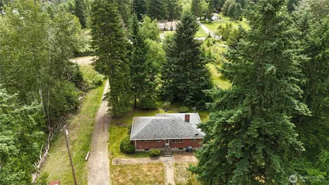 an aerial view of a house with yard swimming pool and outdoor seating