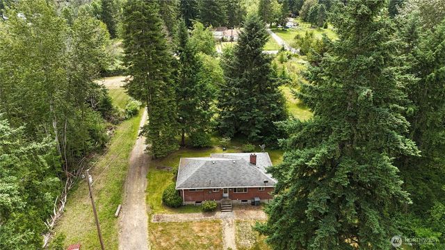 an aerial view of a house with yard swimming pool and outdoor seating