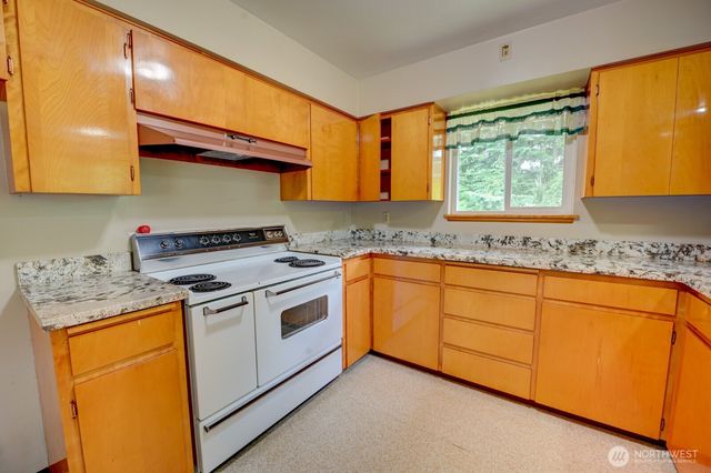 a kitchen with granite countertop cabinets stainless steel appliances and a sink