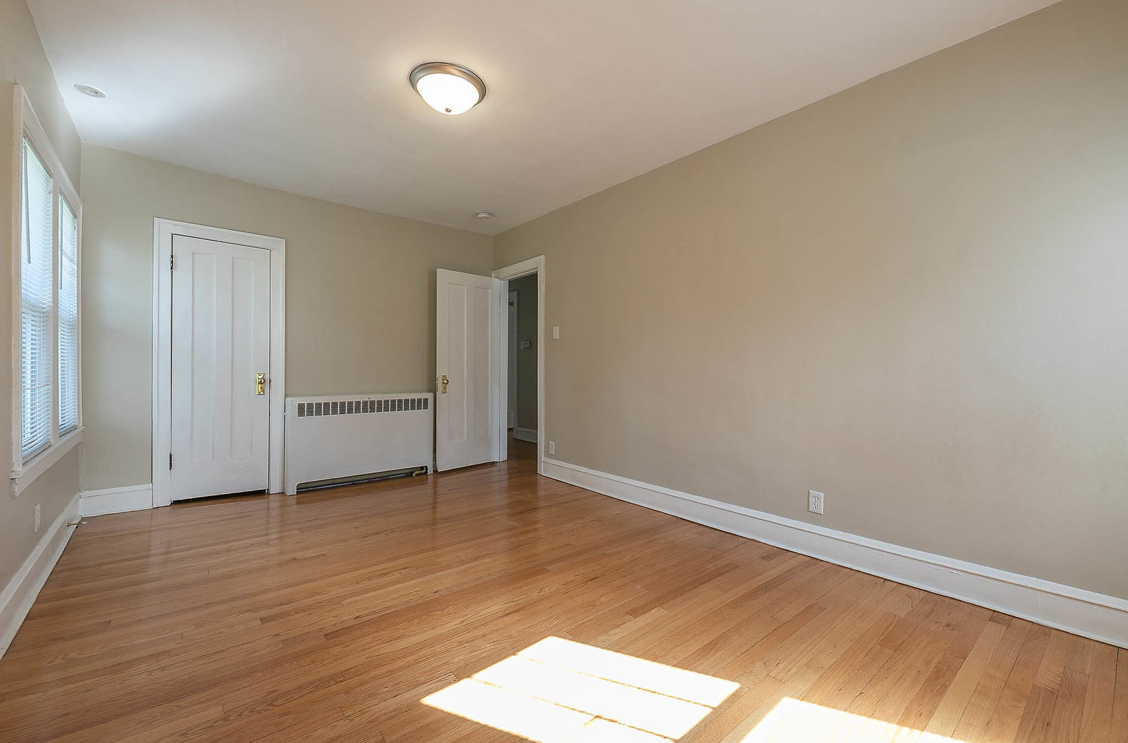 452 Loudon Road Riverside, IL 60546 - Photo 13 of 28 an empty room with wooden floor and windows