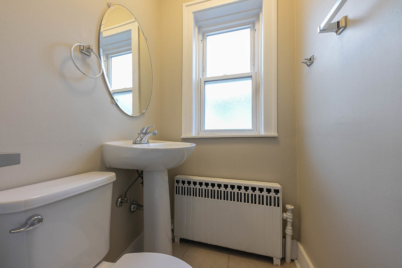 452 Loudon Road Riverside, IL 60546 - Photo 20 of 28 a bathroom with a sink a mirror a toilet and a window