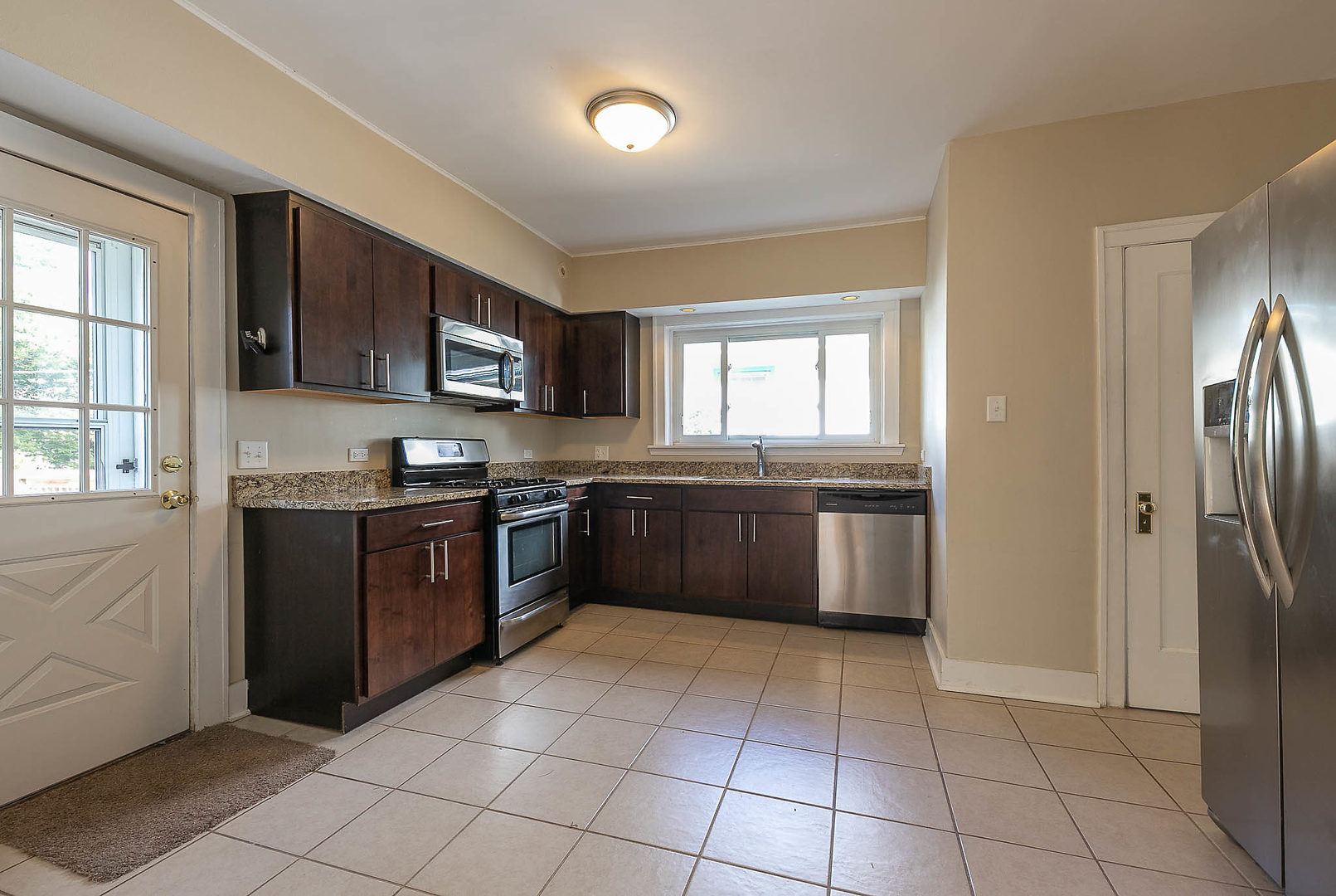 452 Loudon Road Riverside, IL 60546 - Photo 3 of 28 a kitchen with stainless steel appliances granite countertop a stove sink and cabinets