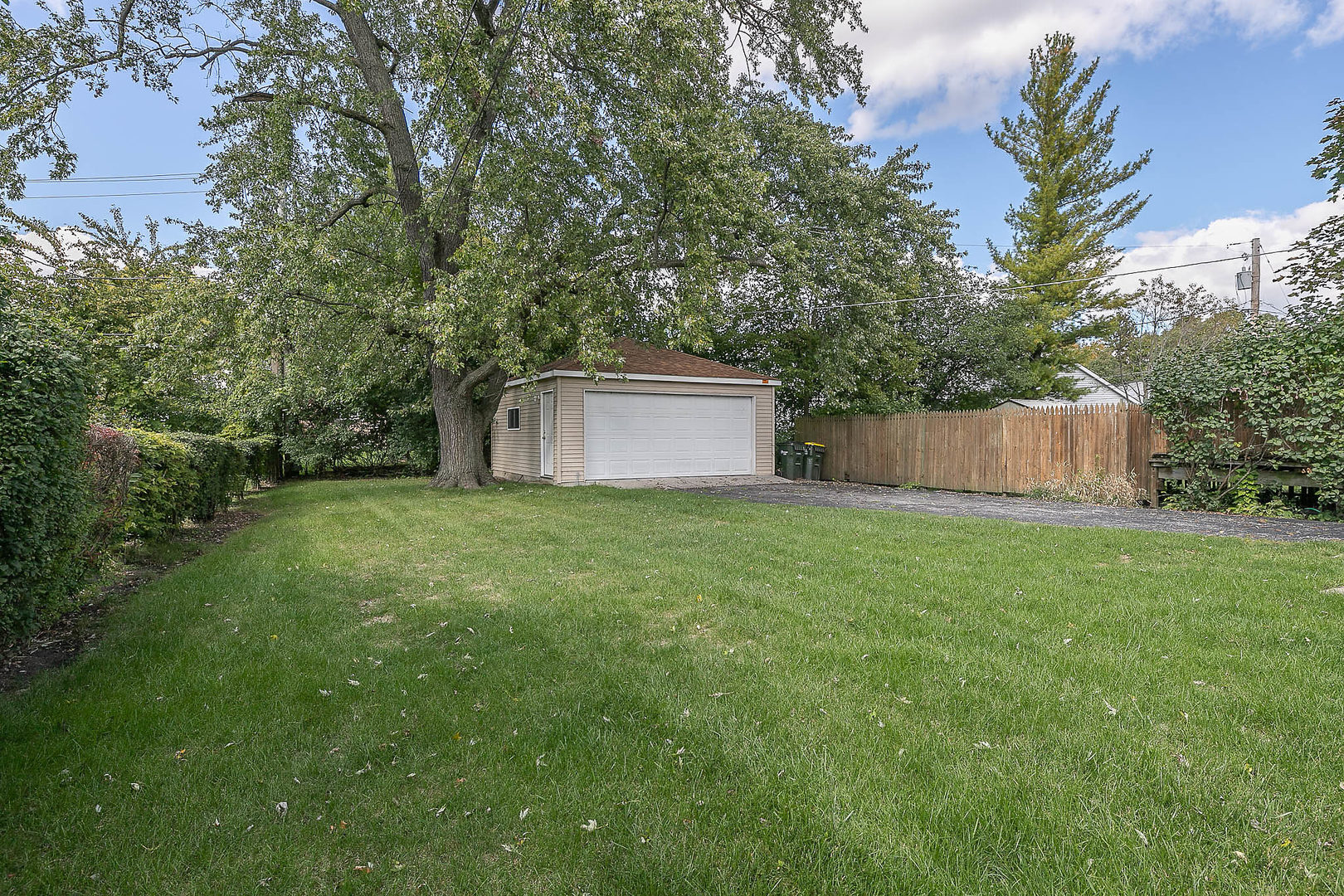 452 Loudon Road Riverside, IL 60546 - Photo 27 of 28 a backyard of a house with plants and large tree
