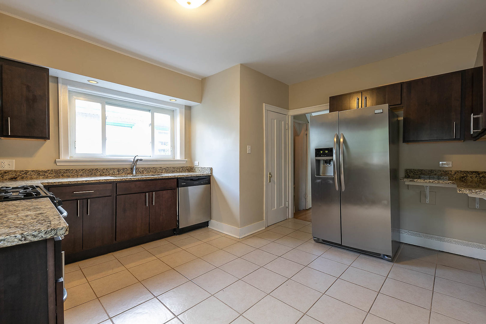 452 Loudon Road Riverside, IL 60546 - Photo 5 of 28 a kitchen with stainless steel appliances granite countertop a refrigerator and a sink