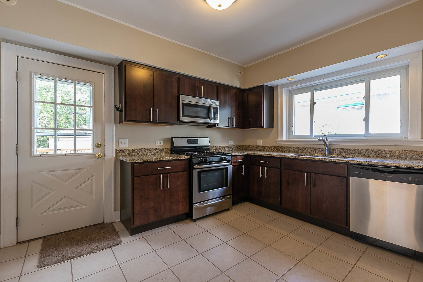 452 Loudon Road Riverside, IL 60546 - Photo 6 of 28 a kitchen with stainless steel appliances granite countertop a stove sink and microwave