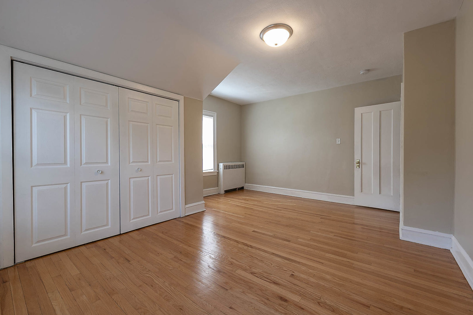 452 Loudon Road Riverside, IL 60546 - Photo 10 of 28 wooden floor in an empty room with a window