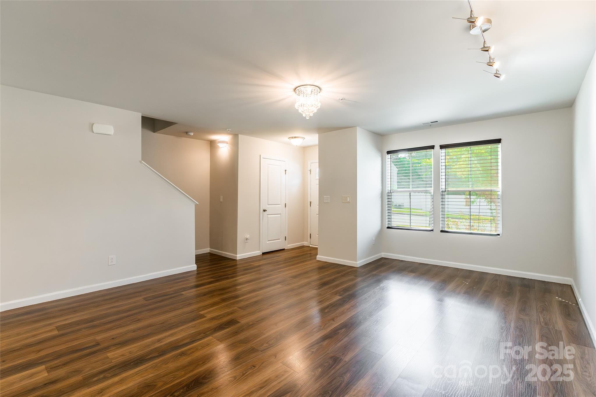 1128 Tangle Ridge Drive Southeast Concord, NC 28025 - Photo 11 of 27 a view of an empty room with wooden floor and a window