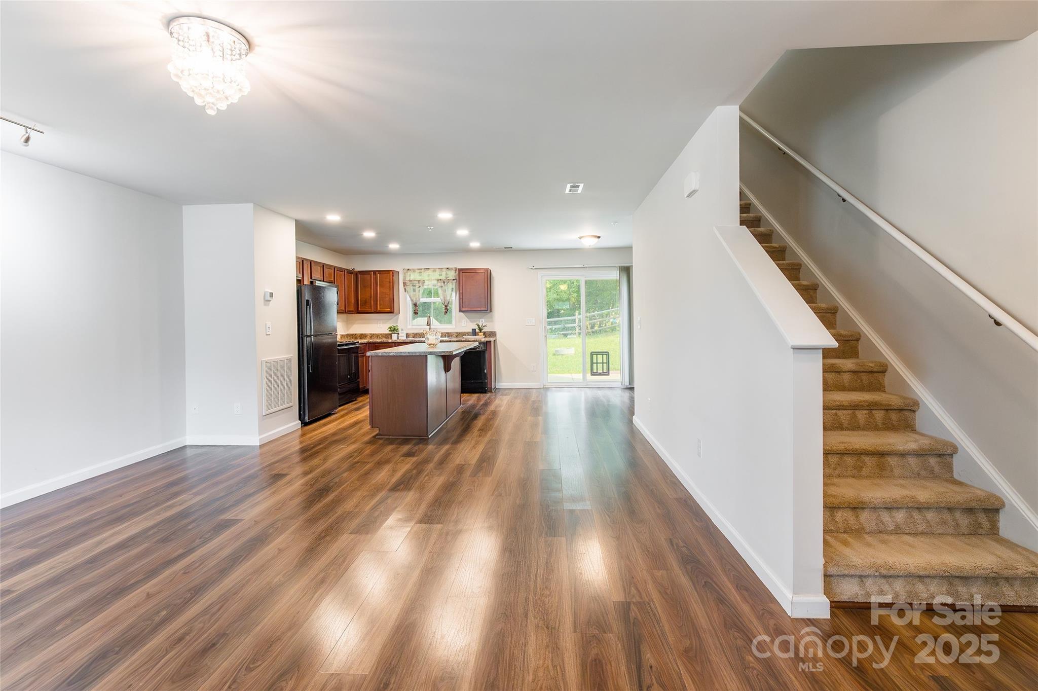 1128 Tangle Ridge Drive Southeast Concord, NC 28025 - Photo 12 of 27 a view of a kitchen with wooden floor and electronic appliances