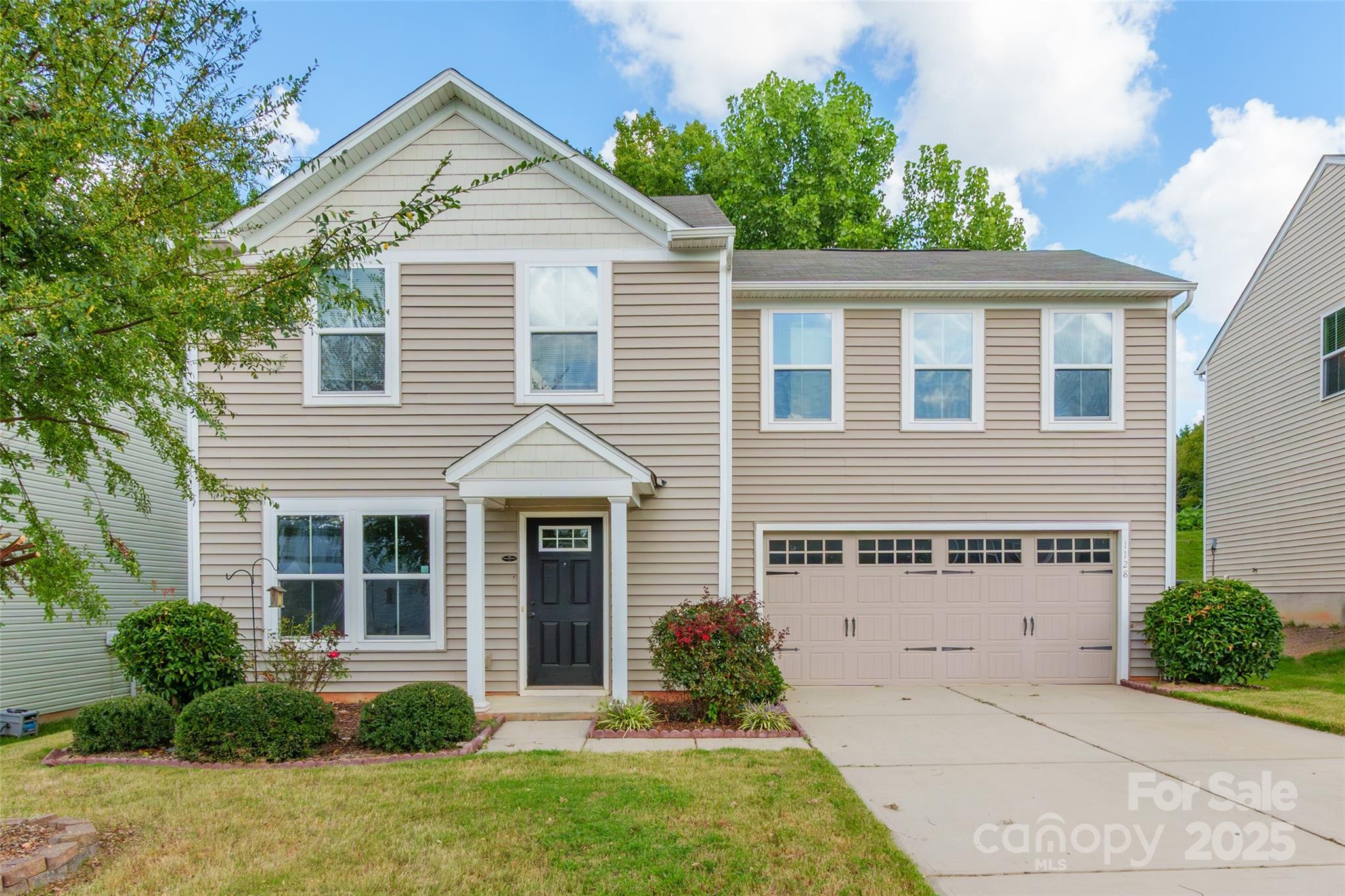 1128 Tangle Ridge Drive Southeast Concord, NC 28025 - Photo 2 of 27 front view of a house and a yard