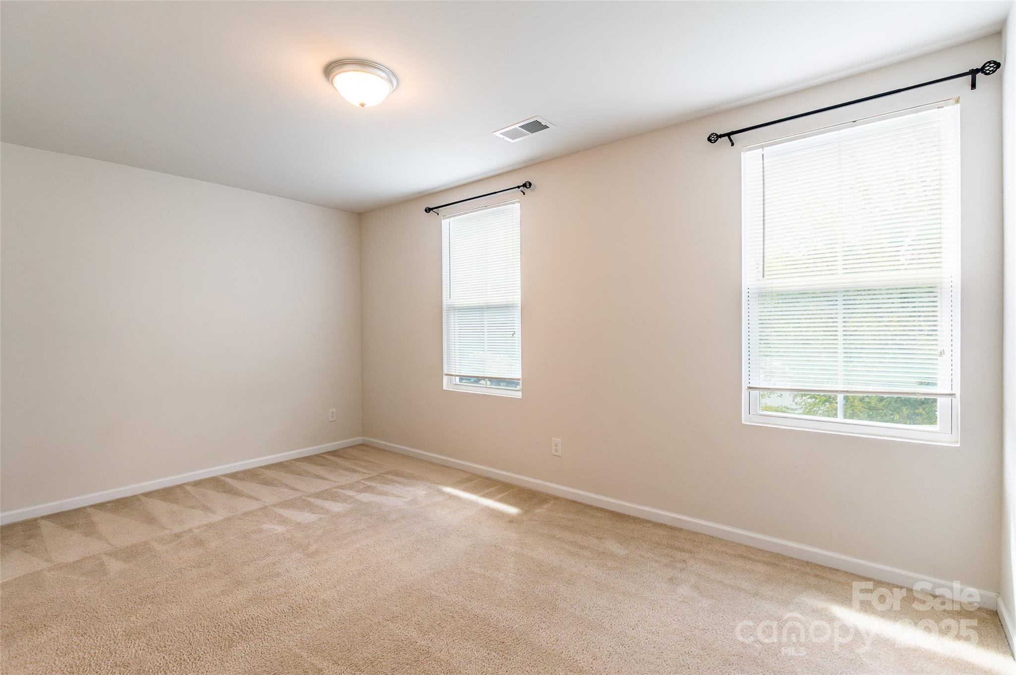 1128 Tangle Ridge Drive Southeast Concord, NC 28025 - Photo 22 of 27 an empty room with windows