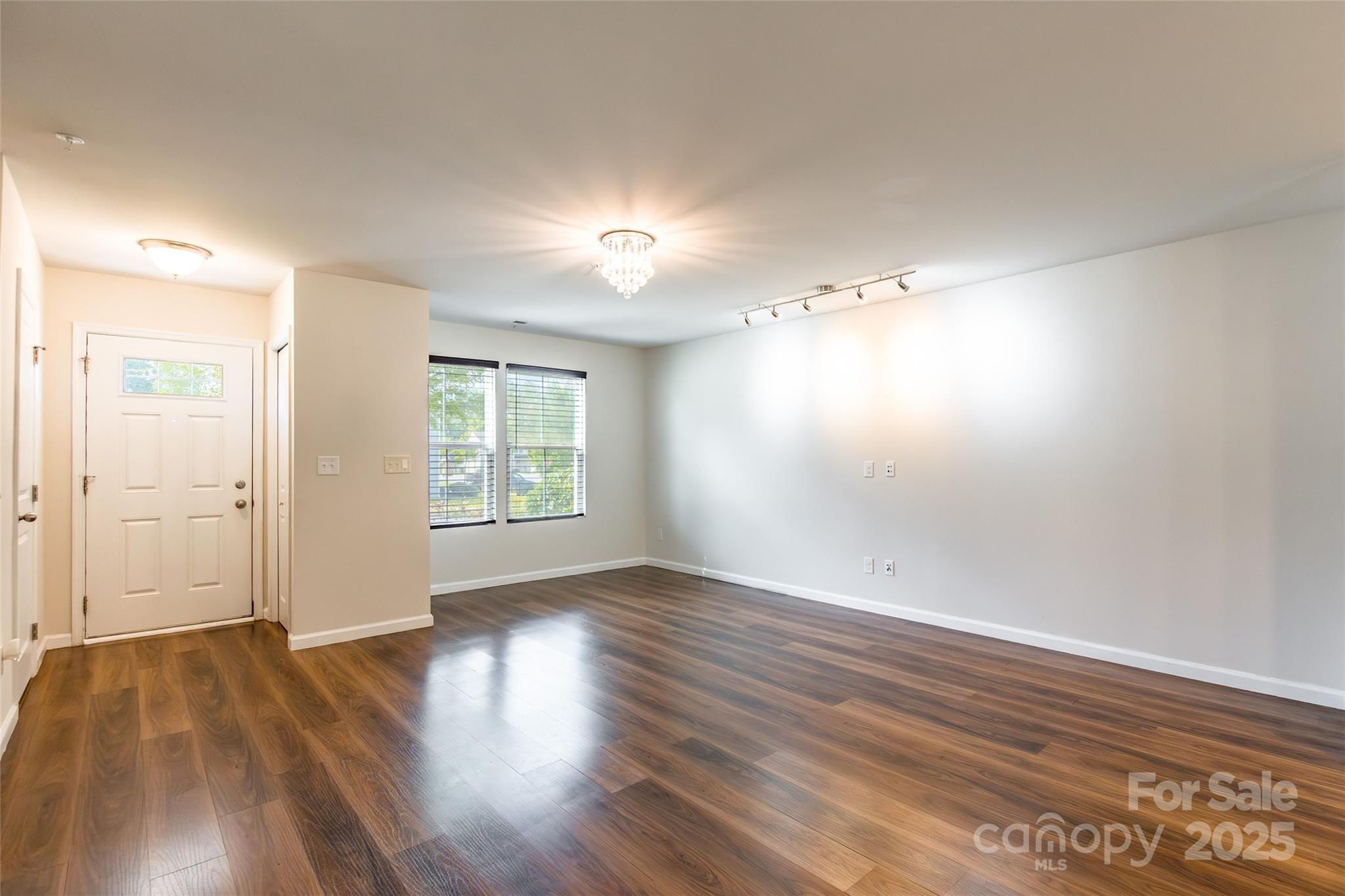 1128 Tangle Ridge Drive Southeast Concord, NC 28025 - Photo 3 of 27 an empty room with wooden floor and windows
