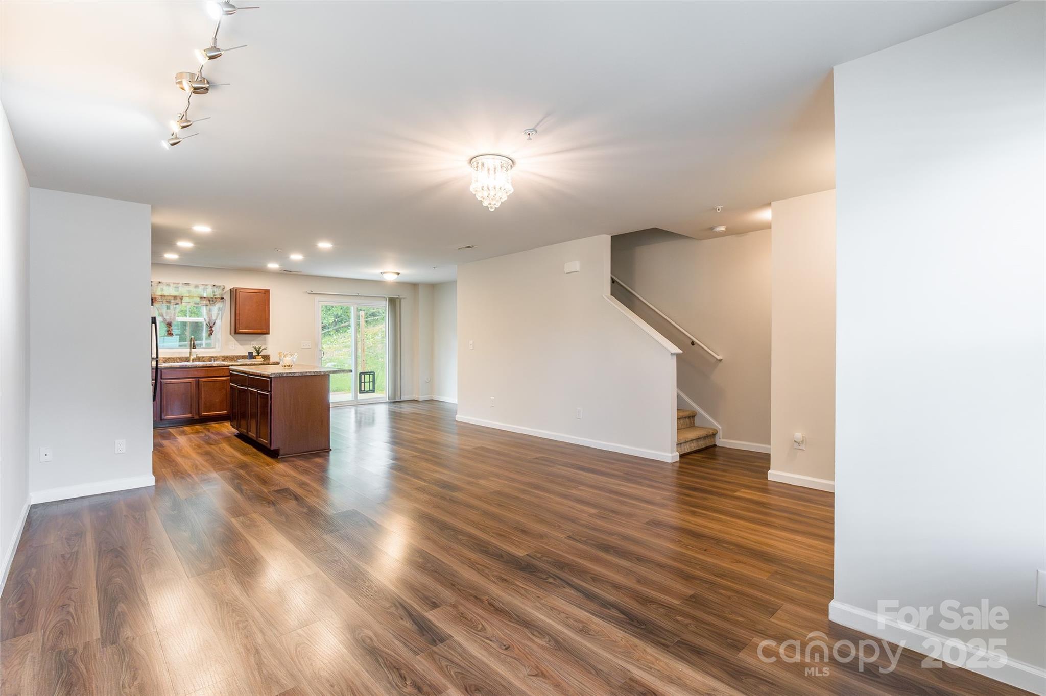 1128 Tangle Ridge Drive Southeast Concord, NC 28025 - Photo 4 of 27 a view of kitchen and hall with wooden floor